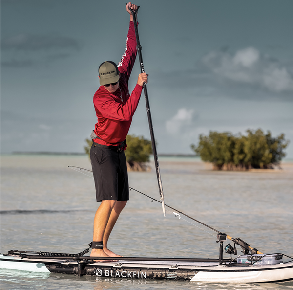 Man standing on paddleboard using the Blackfin sand spear  Lifestyle